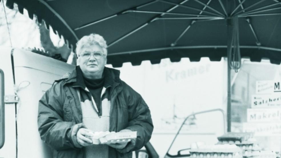 Käthe Siemers steht inmitten der leeren Eierkartons unter ihrem grünen Schirm auf dem Wochenmarkt in Weener - das Bild gehört ab jetzt der Vergangenheit an. Die Aufnahme machte Matthias Löcker für seine »Menschen in Weener«-Ausstellung 2006. © Foto: Matthias Löcker / arte.fakt