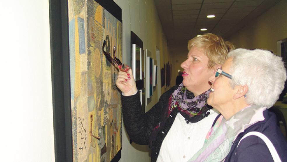 Diese zwei Besucherinnen nehmen die Werke von den Malerinnen Johanna Schmidt und Hanne Frerker aus Weener genau unter die Lupe.  © Fotos: Boelmann