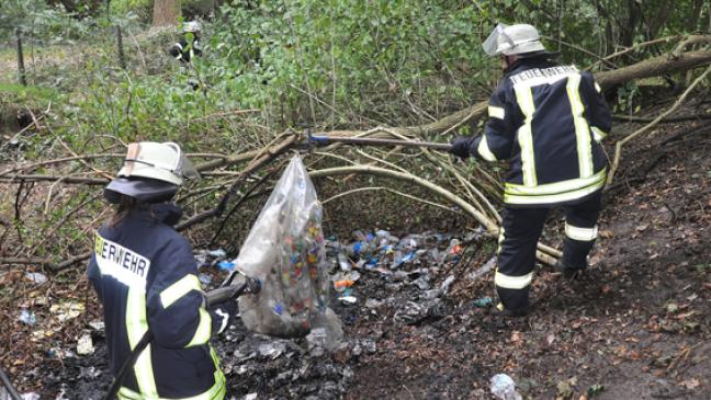 Sträucher und Unrat in Brand geraten