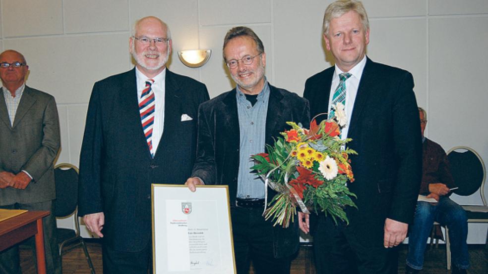 Heiger Scholz, Hauptgeschäftsführer des Niedersächsischen Städtetages, ehrte Lutz Drewniok für sein Engagement im Rat. Rechts Bürgermeister Ludwig Sonnenberg. © Foto: Hoegen