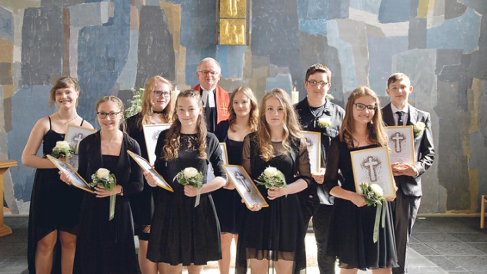 Die neun Konfirmanden: (von links) Sophie Radefeld, Hannah de Vries, Nathalie Geber, Diana Bertram, Pastor Rolf Kemner, Maria Quasr, Michelle Nanninga, Jannek Pals, Marie Maeder und Maik Sangen. © Foto: Himstedt