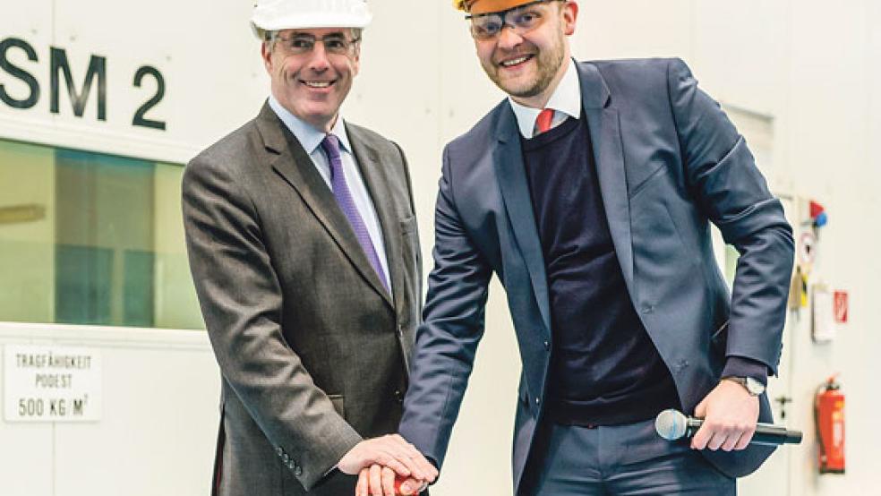 Brennstart: Saga-Vorstandschef Lance Batchelor (links) und Werft-Geschäftsführer Tim Meyer drückten den Startknopf der computergesteuerten Brennmaschine, die die erste Stahlplatte für das neue Schiff bearbeitet. © Foto: Wessels (Meyer Werft
