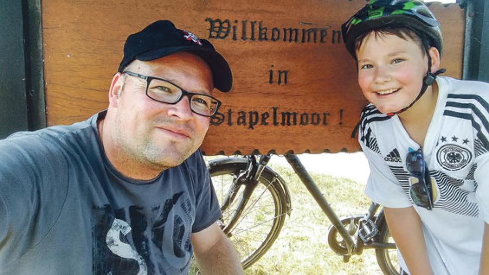 Am Startpunkt ihrer Radtour: Jörg Gelder und sein Sohn Hauke am »Willkommen in Stapelmoor«-Schild am Ortseingang. Ziel der Radtour war das 80 Kilometer entfernte Neuharlingersiel. © Foto: privat