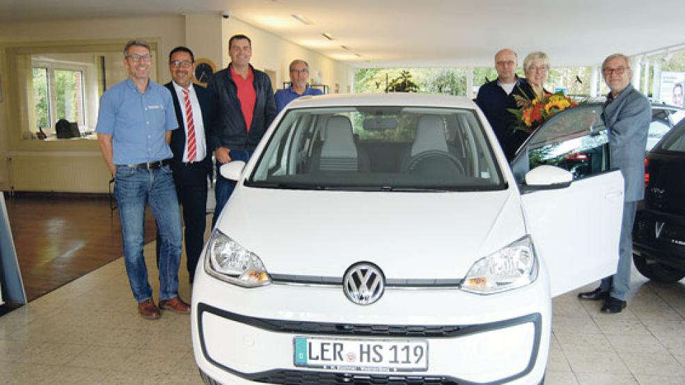 Evert Pastoor (rechts) als Vorsitzender der Werbegemeinschaft gratulierte Heike Siemers mit einem Blumenstrauß zum Hauptgewinn. Neben ihr Arno Broes. Links im Bild Andree Tammen vom Autohaus Züchner, Kassenwart Hermann Hanschel sowie Michael Koenen und Klaus-Dieter Fokken vom Aktionsausschuss der Werbegemeinschaft. © Foto: Hoegen