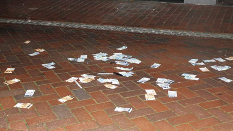 Das Geld liegt auf der Straße: Nach der Sprengung des Geldautomaten in Weener verloren die Täter etwa 10.000 Euro ihrer Beute. © Foto: Rand (Feuerwehr)