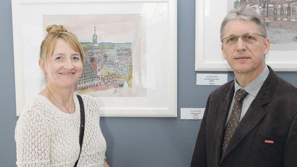 Elena Kuzmina (links) mit Hauptgeschäftsführer Jörg Frerichs (rechts) vor einigen ihrer Stadtansichten von Leer. © Foto: HWK/T. Freesemann