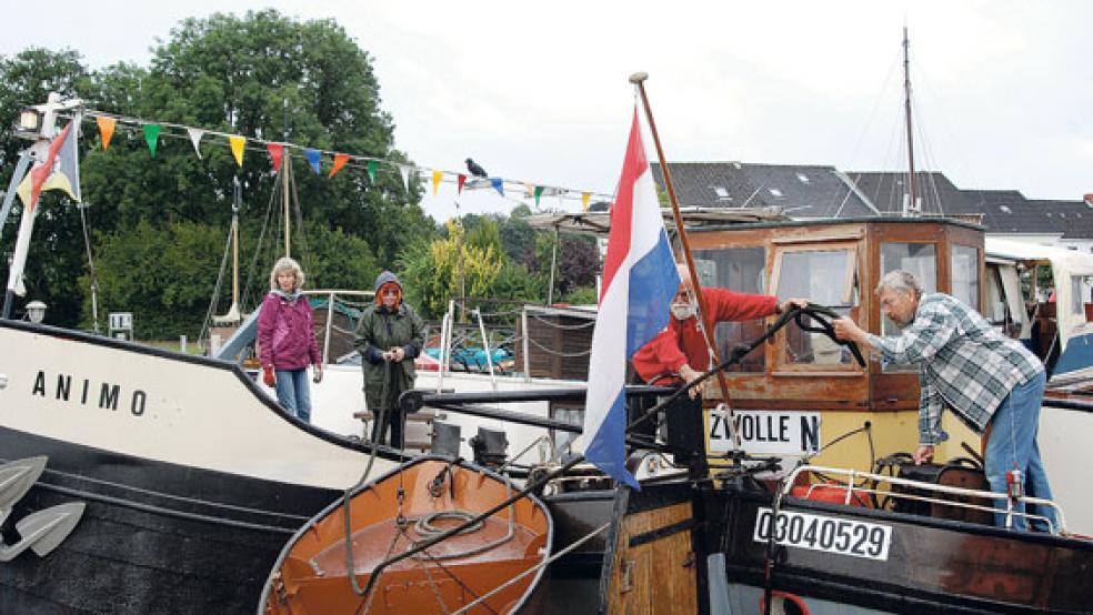 Die »Animo« legt neben der »Dankbaarheid« im Hafen von Weener an. Skipper Han Visser von der »Dankbaarheid« und Klaus Manderscheid (rechts) packen mit an, um die Festmacherleine an einem Poller zu vertäuen. © Foto: Hoegen