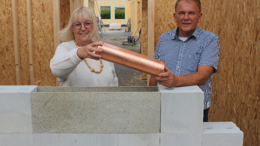 Helma Timmer und Gerald Sap mauerten gemeinsam die »Zeitkapsel« beim Krippen-Neubau am Leega Weg ein. © Berents