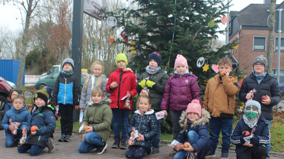 Die Erstklässler der Grundschule Möhlenwarf schmückten am Freitag mit großer Begeisterung den Weihnachtsbaum vor dem NP-Markt am Kreisel. © Foto: Berents