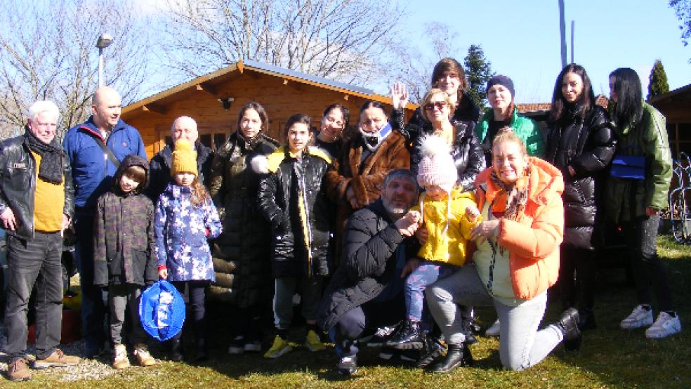 Heinz-Dieter Hoppen (links) und seine Frau Irina (rechts kniend) haben vorübergehend insgesamt 15 Kriegsflüchtlinge aus der Ukraine bei sich aufgenommen. Die fünf Kinder, zwei Jugendlichen und acht Erwachsenen sind am 24. Februar mit Privatwagen in der Stadt Dnipro aufgebrochen und in der Nacht zu Freitag in Möhlenwarf eingetroffen. © Foto: Szyska