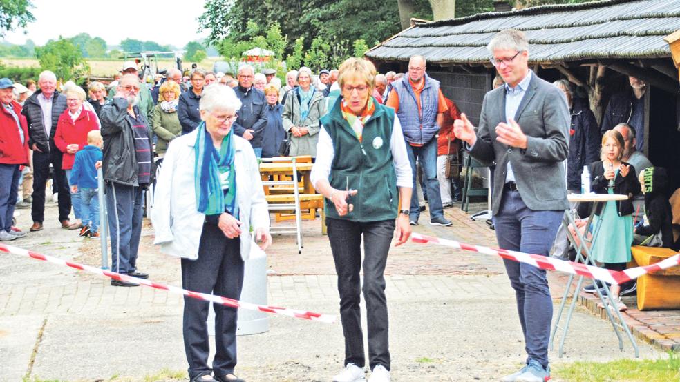 Rund 160 Besucher kamen zur Eröffnungsfeier des historischen Melkstands in Weenermoor. Nach dem Durchschneiden des symbolischen Absperrbandes durch Eigentümerin Frieda Alberts (von links) und Jeane Schmidt in Anwesenheit von Bürgermeister Heiko Abbas gab es einen plattdeutschen Gottesdienst.  © Foto: privat