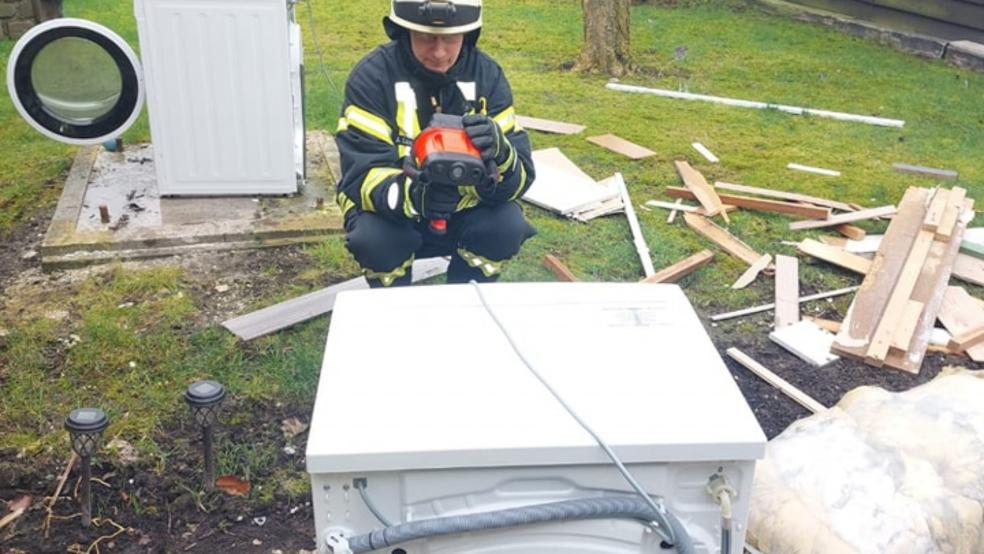 Die Einsatzkräfte der Feuerwehr beförderten die Waschmaschine ins Freie, löschten sie dort ab und kontrollierten die Wirkung anschließend mit der Wärmebildkamera.  © Feuerwehr Jemgum