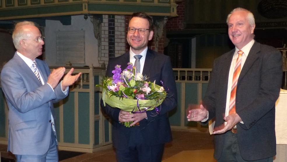 Regionalbischof Dr. Detlef Klahr (links) und der Vorsitzende der Kirchenkreissynode und des Wahlausschuss, Theo Weber (rechts), gratulierten Pastor Christian Neumann in der Ludgeri-Kirche Norden zur Wahl als Superintendent des Kirchenkreises Norden. © Marika Cuno
