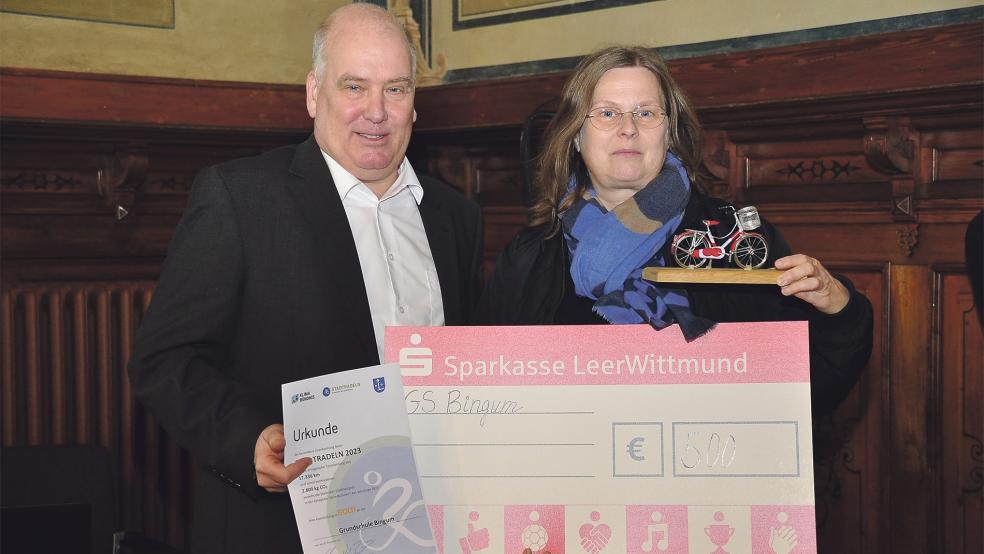 Der Leeraner Bürgermeister Claus Peter Horst überreichte der Leiterin der Bingumer Grudnschule, Marion de Buhr, einen Scheck in Höhe von 500 Euro. Die Bingumer belegten bei den Grundschulen den ersten Platz beim Stadtradeln.  © Foto: Wolters