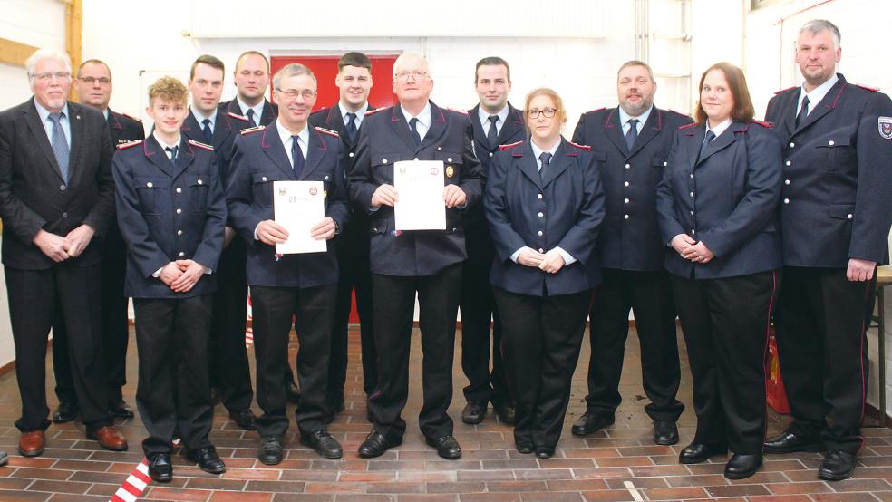 Gastgeber und Gäste (von links): Ortsvorsteher Bernhard Siemons, Stadtbrandmeister Jörg Fisser, Jonas Brandt, Dennis Modder, der stellvertretende Stadtbrandmeister Steffen Voß, Sander Sander (mit Urkunde), Phillip Kromminga, Enno Nagel (mit Urkunde), Ingo Stanschus, Friederike Bleeker, der stellvertretende Ortsbrandmeister Siegfried Buttjes, Cyra Winands und Ortsbrandmeister Thorsten Duismann.  © Foto: Rand (Feuerwehr)