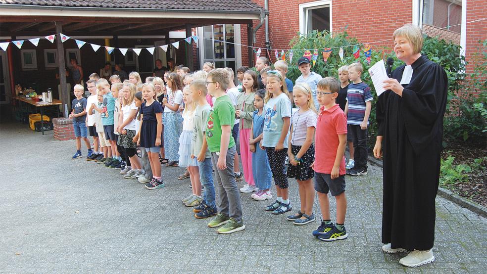 Pastorin Anne Ulferts sang gemeinsam mit dem Schulchor der Grundschule Möhlenwarf bei der Einschulungsfeier.  © Hoegen