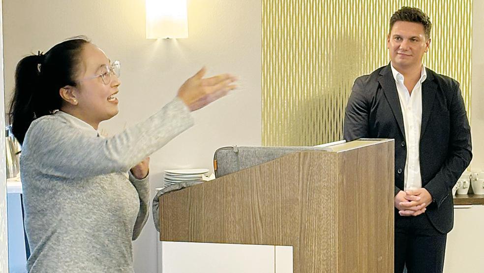 Die Vietnamesin Thi Hong Linh Thach berichtete von ihrem Ausbildungsalltag in der Inselbäckerei Bethke auf Norderney. Im Hintergrund: Jelto Müller, Geschäftsführer der Wirtschaftsförderung Landkreis Aurich (WLA).  © Foto: Landkreis Aurich