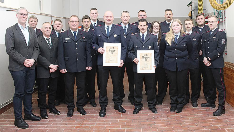 Gastgeber und Ehrengäste: Von links Bürgermeister Heiko Abbas, Hans-Georg Duhm, Ortsvorsteher Garrelt Janssen, Hans-Jürgen Yzer, Stadtbrandmeister Jörg Fisser, Timo Meeuw, der stellvertretende Ortsbrandmeister Vincent Hassler, Ingo Wolters (Ehrung für 25 Jahre, mit Urkunde), Andy Yzer, Uwe Barth (25 Jahre), Florian Holtkamp, Tomke Ostendorp, Jayden Donderwinkel, Anke Yzer, Caylen Ulver, Wenko Kuper und Ortsbrandmeister Nico Diddens.  © Foto: Feuerwehr/Rand
